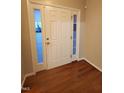 Front entry with hardwood floors and a white door at 302 Glenview Ln, Durham, NC 27703