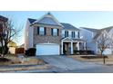 Two-story brick home with gray siding, two-car garage, and landscaping at 302 Glenview Ln, Durham, NC 27703