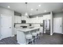 Bright kitchen featuring white cabinets, stainless steel appliances, and an island at 365 Fosterton Cottage Way, Raleigh, NC 27603