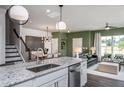 Modern kitchen with island, stainless steel appliances and open to living area at 371 Fosterton Cottage Way, Raleigh, NC 27603