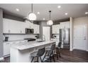 Modern kitchen with white cabinets, granite countertops, and stainless steel appliances at 371 Fosterton Cottage Way, Raleigh, NC 27603