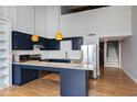Modern kitchen with navy cabinets, granite counters, and stainless steel appliances at 500 N Duke St # 55-306, Durham, NC 27701
