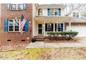 Brick front porch with blue shutters and American flag at 516 Argyll Dr, Sanford, NC 27332