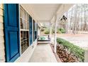 Side porch with a swing and lush green bushes at 516 Argyll Dr, Sanford, NC 27332
