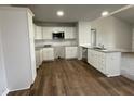 Modern kitchen featuring white cabinets, granite countertops, and stainless steel appliances at 57 Shiloh Dr, Lillington, NC 27546