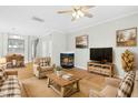 Bright living room with fireplace, hardwood floors, and stylish furniture at 5734 Corbon Crest Ln, Raleigh, NC 27612