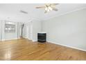 Living room featuring hardwood floors, a fireplace, and ceiling fan at 5734 Corbon Crest Ln, Raleigh, NC 27612