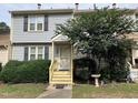 Gray two-story townhome with yellow steps and landscaping at 6548 English Oaks Dr, Raleigh, NC 27615