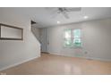 Bright living room with laminate floors and ceiling fan at 6548 English Oaks Dr, Raleigh, NC 27615