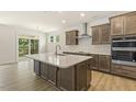 Modern kitchen with ample cabinetry, quartz countertops, and a breakfast bar at 72 Demascus Way, Four Oaks, NC 27524