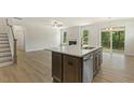 Open concept kitchen with large island, stainless steel appliances, and hardwood floors at 72 Demascus Way, Four Oaks, NC 27524