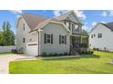 Two-story house with gray siding, stone accents, and a covered porch at 810 Mulberry Rd, Spring Hope, NC 27882