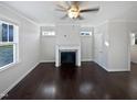 Living room with dark hardwood floors and a fireplace at 917 Palm Ct, Mebane, NC 27302