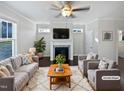 Virtually staged living room with fireplace and neutral colored furniture at 917 Palm Ct, Mebane, NC 27302
