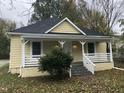 Charming yellow home with a welcoming front porch and well-maintained landscaping at 1312 Fay St, Durham, NC 27701