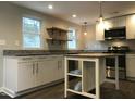 Modern kitchen with stainless steel appliances and island at 1312 Fay St, Durham, NC 27701