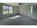 Spacious bedroom with new carpet and large windows at 16 Holly Grove Ln, Lillington, NC 27546