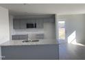 Modern kitchen with gray cabinets and granite countertops at 16 Holly Grove Ln, Lillington, NC 27546