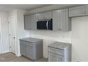 Modern kitchen with gray cabinets and granite countertops at 16 Holly Grove Ln, Lillington, NC 27546