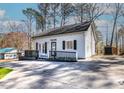White house with black accents and a large front deck at 164 Pinto Dr, Louisburg, NC 27549