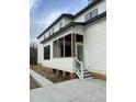 Side view of a white house showcasing a screened porch at 318 Hinton St, Apex, NC 27502