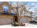 Attractive townhome with stone and siding, 2-car garage, and landscaping at 324 Sunstone Dr, Cary, NC 27519