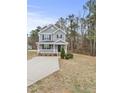 Two-story gray house with white trim, front porch, and driveway at 3928 Mike Levi Ct, Raleigh, NC 27610