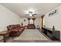 Living room with brown leather couches and a large area rug at 3928 Mike Levi Ct, Raleigh, NC 27610