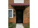 Condo front door with brick facade at 4519 Edwards Mill Rd # J, Raleigh, NC 27612