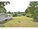 Large backyard with a view of neighboring houses at 5617 Laurel Crest Dr, Durham, NC 27712