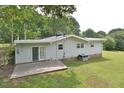 Home's back features a patio and spacious grassy area at 5617 Laurel Crest Dr, Durham, NC 27712