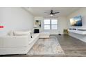 Living room featuring a sectional sofa, large TV, and hardwood floors at 601 Joe Gibson Dr, Gibsonville, NC 27249