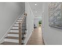 Modern staircase with dark wood treads and black metal balusters at 712 Jamescroft Way # 26, Rolesville, NC 27571