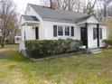A charming home boasts manicured landscaping and a cozy side porch at 734 Baker St, Oxford, NC 27565