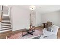 Inviting living room featuring hardwood floors, staircase, and abundant natural light at 10519 Pleasant Branch Dr # 43, Raleigh, NC 27614