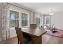 Bright living area with large windows, hardwood floors, and stylish decor at 10519 Pleasant Branch Dr # 43, Raleigh, NC 27614