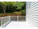 White deck overlooking a wooded area with a wooden retaining wall at 129 Weatherhill Pt, Carrboro, NC 27510