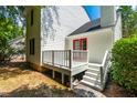 White deck with red door access and wooden railings at 129 Weatherhill Pt, Carrboro, NC 27510