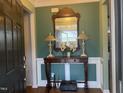 Inviting entryway with a decorative mirror and console table at 13 E Milan Ct, Clayton, NC 27527