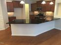 Modern kitchen featuring a large island and granite countertops at 13 E Milan Ct, Clayton, NC 27527