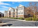 Exterior view of apartments with brick facade, balconies, beautiful landscaping, and ample parking at 2621 Oldgate Dr # 105, Raleigh, NC 27604