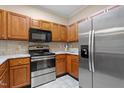 Stainless steel appliances and wood cabinets at 2621 Oldgate Dr # 105, Raleigh, NC 27604