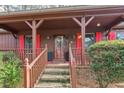 Inviting front porch with red shutters and wooden steps leading to the entrance at 314 Mill Creek Dr, Fuquay Varina, NC 27526