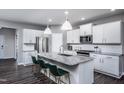 Spacious kitchen with white cabinets, granite island, and stainless steel appliances at 432 Providence Springs Ln, Fuquay Varina, NC 27526