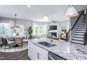 Modern kitchen with white cabinets, granite countertops, and stainless steel appliances at 432 Providence Springs Ln, Fuquay Varina, NC 27526
