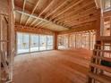 Interior framing of a large living space featuring sliding glass doors to a deck at 7934 Wexford Waters Ln, Wake Forest, NC 27587