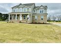 Inviting two-story home with classic architectural details and a spacious front yard at 90 Demascus Way # 024, Four Oaks, NC 27524