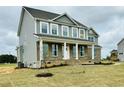 Beautiful two-story home with modern siding, a well-manicured lawn, and attractive landscaping at 90 Demascus Way # 024, Four Oaks, NC 27524