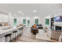 Open floor plan with a white kitchen, island, and a gray sectional sofa at 0 Hanover Dr, Sanford, NC 27330