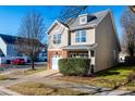 Two-story townhome with brick accents and attached garage at 105 Danesway Dr, Holly Springs, NC 27540